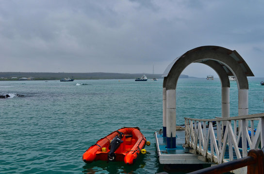 Boat Dock and Zodiac with Anchored Boats in the Bay in the Galapagos Islands Ecuador