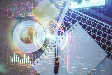 Double exposure of data drawing hologram over topview of study desk background with computer. Concept of Ai.