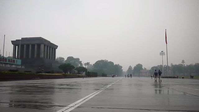 Ho Chi Minh mausoleum in the rain with the Vietnamese flag