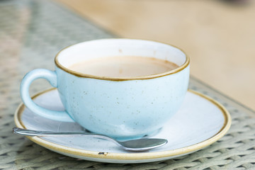 Cup of fresh aromatic coffee on the table close up.