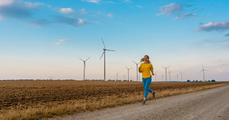 Woman running or jogging down a path in the countryside