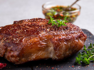 Juicy roasted beef steak with spices and thyme, close up