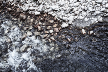 Background of stones and pebbles on the river side