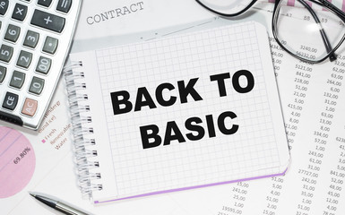 Business concept. Notebook with text BACK TO BASIC sheet of white paper for notes, calculator, glasses, pencil, pen, in the white background