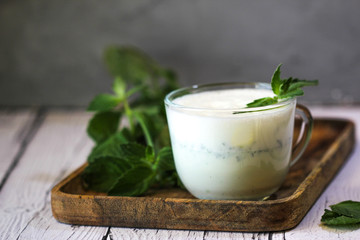 Milkshake with Ice Cream and Mint on wooden background. 