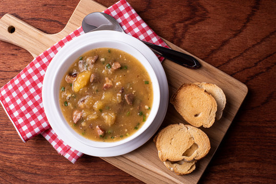 .Cassava broth. Creamy broth made with cassava, sausage, bacon and meat. .Accompanied by toast Top view Top view