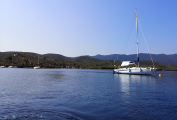 Fototapeta premium A sailboat anchored in a bay