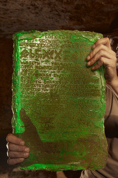Detail of mysterious artifact emerald tablet found by adventurer in cave