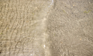 Close up shot of a wave rolling on the shore