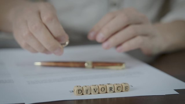 Divorce feelings. The woman changed her mind to sign the divorce papers.