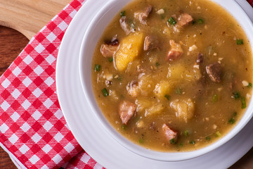 .Cassava broth. Creamy broth made with cassava, sausage, bacon and meat. Top view