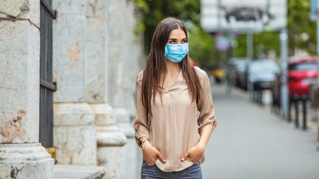People with face mask. Concept with copy space. Portrait of adult woman in quarantine of flu. Photo on the street in the city. Picture for coronavirus covid-19 (SARS-CoV-2)