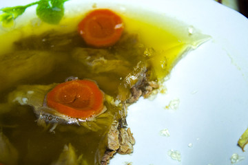 Home made aspic, jellied chicken meat with herbs and carrots. Traditional Russian dish holodets....