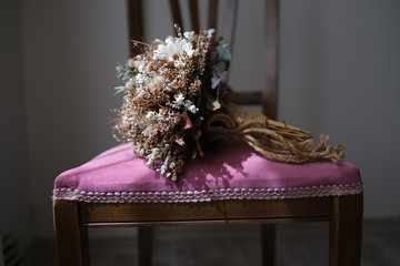 Bridal bouquet of dried flowers on chair