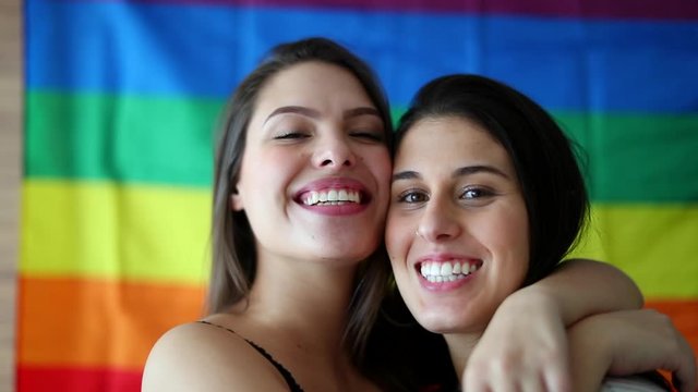 Two LGBT lesbian girlfriends posing to camera. Female gay couple smiling at camera