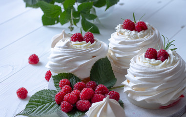 Pavlova meringue cakes close-up with fresh raspberries