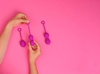 woman holds a kegel trainer. Latex vaginal vibrator for training the pelvic floor muscles with an antenna. The device for imbuilding. Women Health. High quality . Copy space. Banner