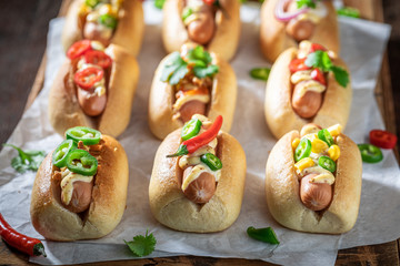 Unhealthy mini hot dogs with pork sausage and sauce - obrazy, fototapety, plakaty