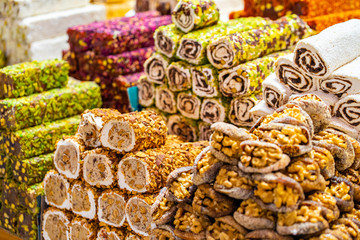 Various bright colored turkish delights sweets baklava lokum and dried fruits vegetables on market in Istanbul, Turkey