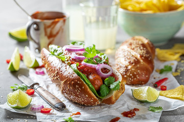 Tasty barbecue hot dogs served with nachos and lemonade