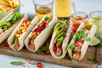Homemade hot dogs with with sausage, sauce and vegetables