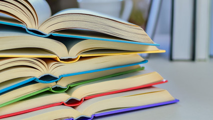 Close up, Desk with stack of open study books. Textbooks for the student, university. Study from...