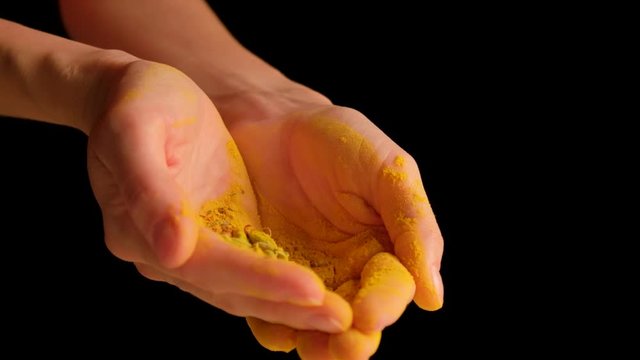the girl is pouring seasonings for cooking in her hands.