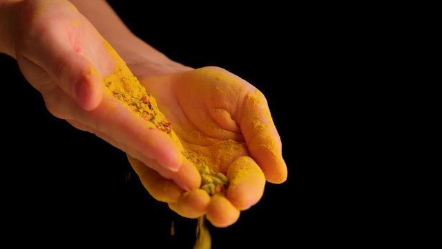 the girl is pouring seasonings for cooking in her hands.
