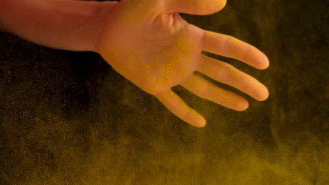 a girl cook with yellow condiments for cooking claps her hands. high quality. slow motion