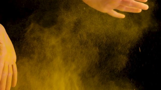 a girl cook with yellow condiments for cooking claps her hands. high quality. slow motion