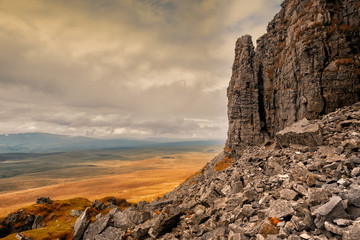 Pen-y-ghent Pinnacle. Pen-y-ghent or Penyghent is a fell in the Yorkshire Dales, England. It is the lowest of Yorkshire's Three Peaks at 2,277 feet; the other two being Ingleborough and Whernside