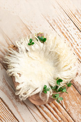 basket for children's photo sessions. background texture for a newborn photo. wooden basket with fur