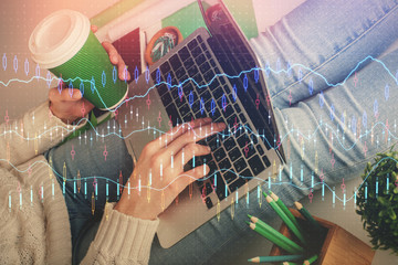 Double exposure of woman hands typing on computer and forex chart hologram drawing. Stock market invest concept.