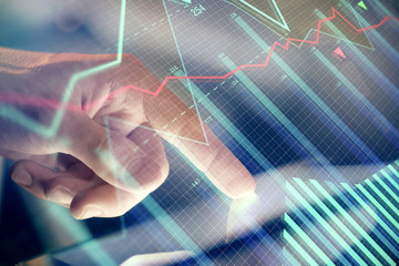 Multi exposure of man's hands holding and using a phone and financial chart drawing. Market analysis concept.