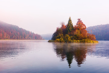 Morning fog on amazing island on Plitvice lakes. Plitvice National Park, Croatia. Landscape...