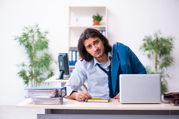 Male employee coming to work straight from bed