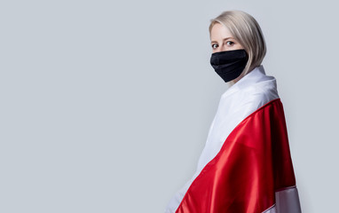 woman in face mask with national Belarus flag on white background