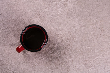 cup of coffee with cement background accompanies cheese bread