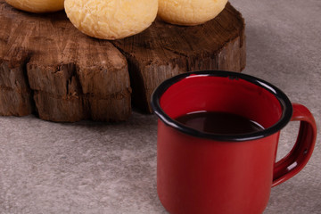 cup of coffee with cement background accompanies cheese bread