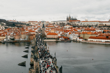 Prague and Vltava, winter season View from above Charles bridge crowded with people