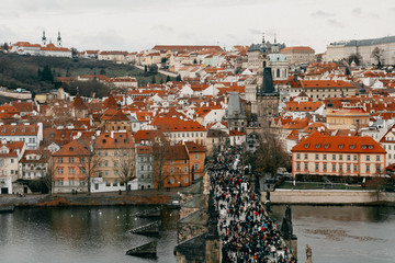 Prague and Vltava, winter season View from above Charles bridge crowded with people