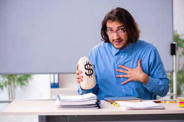 Young male teacher in the classroom