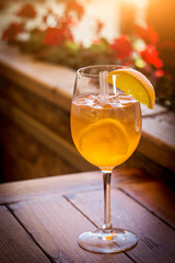 glass of aperol on wooden table