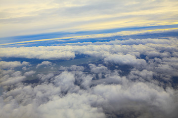 Naklejka premium Clouds from Airplane Window . Flight over the clouds and river 