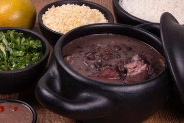 complete feijoada with rice, beans, cabbage, farofa, orange and pepper