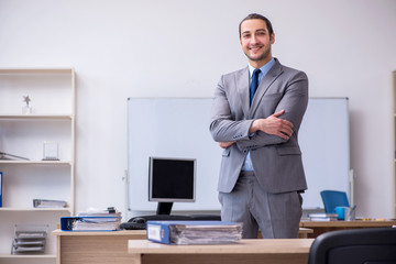 Young male businessman employee working in the office