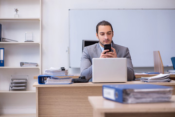 Young male businessman employee working in the office