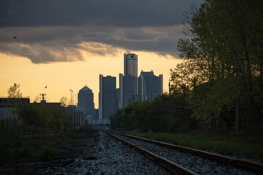 Detroit skyline at the end of railroad tracks at sunset