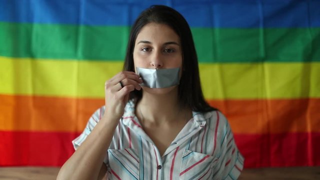 Woman taking off tape with over mouth, democracy LGBT freedom concept