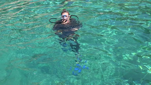 Fethiye, Turkey - 30th of July 2020: 4K Female scuba diver rises to the surface
